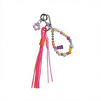 Pink tassel bag charm with colorful beaded "Love" loop and purple gummy bear charm – product view