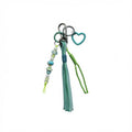 Teal and green nautical rope tassel bag charm with beaded strand and teal heart pendant – product view