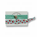 Mint elastic hair tie set with cherry print band and silver starfish charm on Mint Sorbet packaging card