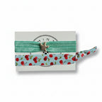 Mint elastic hair tie set with cherry print band and silver starfish charm on Mint Sorbet packaging card