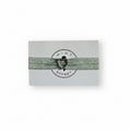 Green elastic bracelet with silver heart charm on Mint Sorbet packaging card