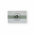 Green elastic bracelet with silver heart charm on Mint Sorbet packaging card