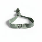 Green elastic bracelet with silver heart charm – product view