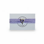 Purple elastic bracelet with silver heart charm on Mint Sorbet packaging card