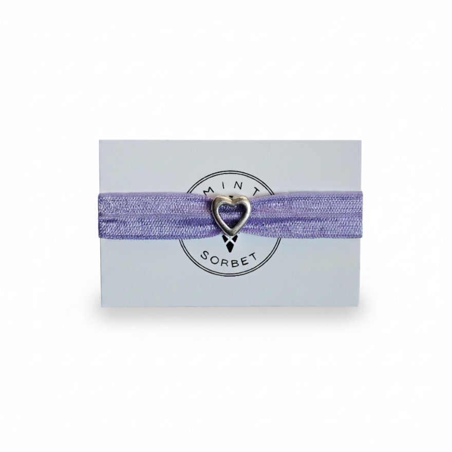 Purple elastic bracelet with silver heart charm on Mint Sorbet packaging card