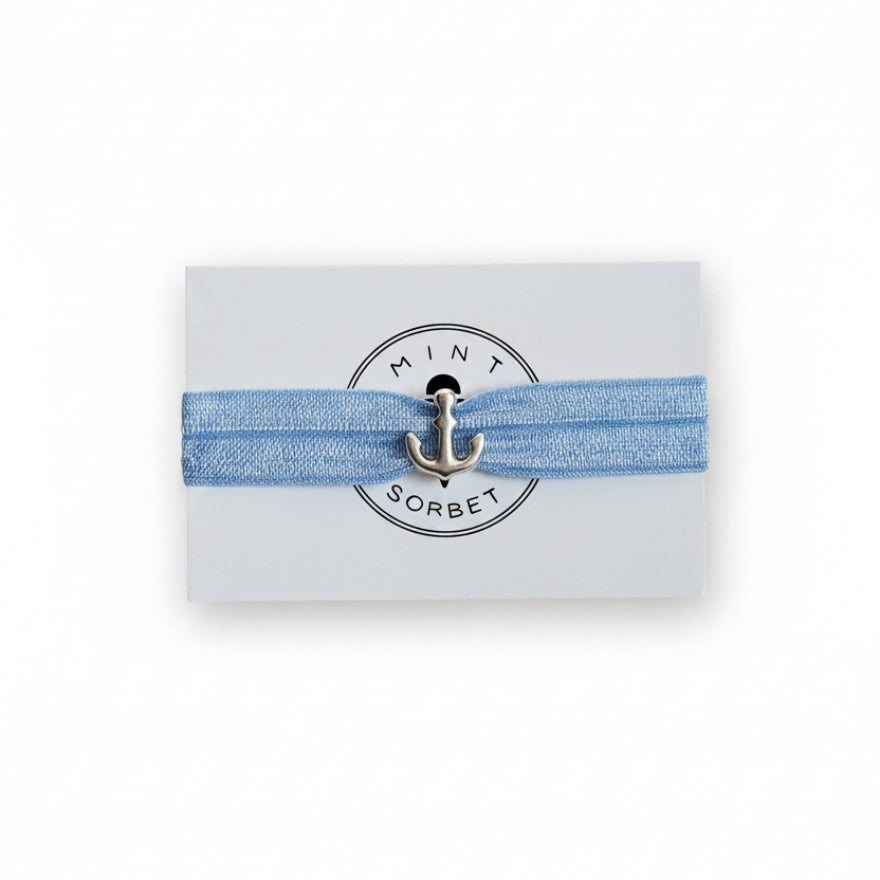 Blue elastic bracelet with silver anchor charm on Mint Sorbet packaging card