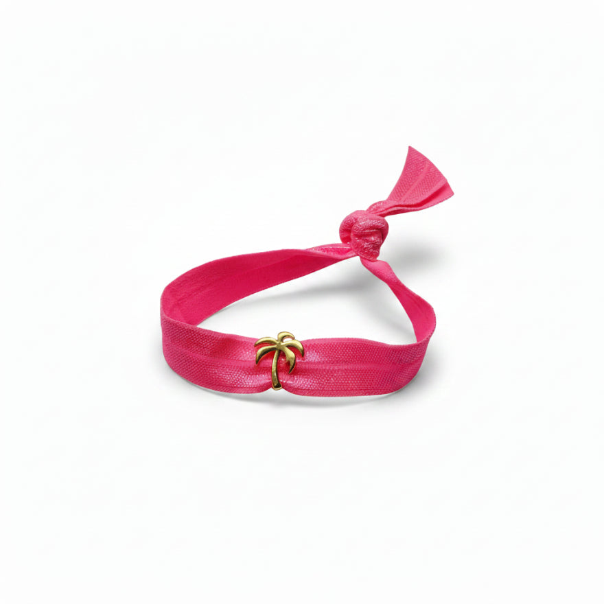 Pink elastic bracelet with gold palm tree charm – product view