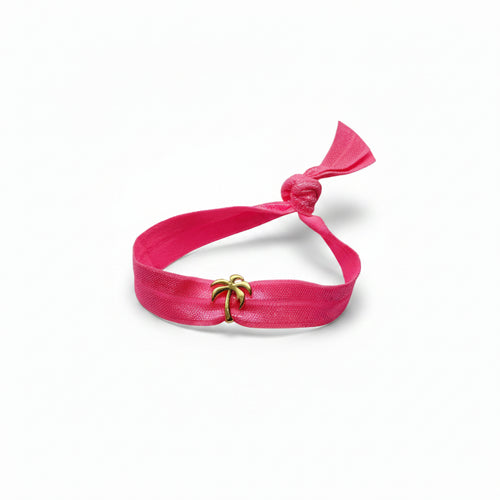 Pink elastic bracelet with gold palm tree charm – product view