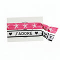 Pink star print and white "J'adore" elastic hair tie set on Mint Sorbet packaging card