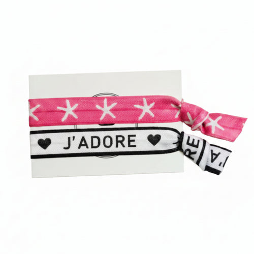 Pink star print and white "J'adore" elastic hair tie set on Mint Sorbet packaging card