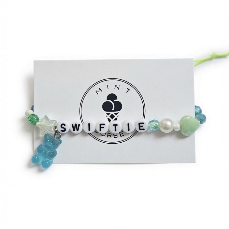 Blue and green beaded "Swiftie" friendship bracelet with gummy bear charm on Mint Sorbet packaging card