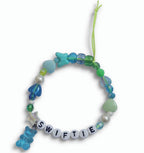 Blue and green beaded "Swiftie" friendship bracelet with gummy bear charm – product view