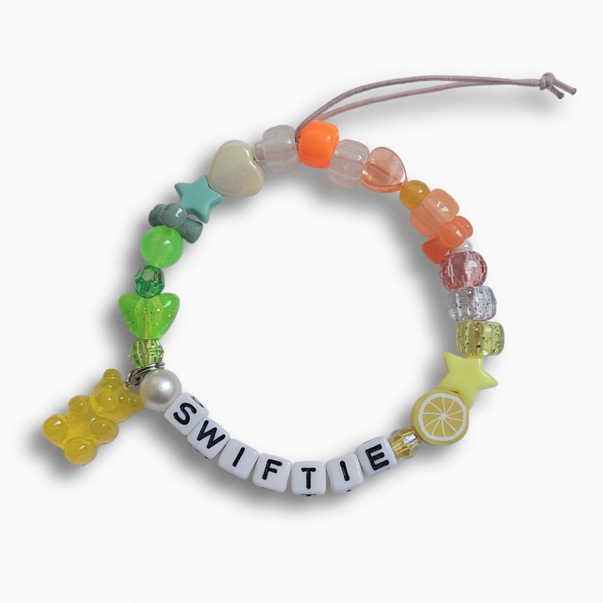 Multicolour beaded "Swiftie" friendship bracelet with yellow gummy bear charm – product view
