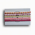 Pink, yellow and cream hand-knotted cotton friendship bracelet set of 5 on Mint Sorbet packaging card