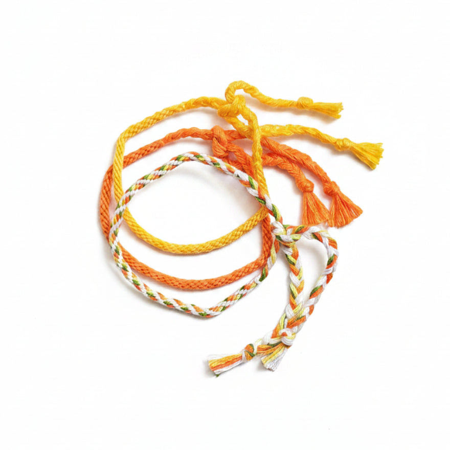 Yellow, orange, green and white hand-knotted cotton friendship bracelet set of 3 – product view