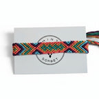 Hand-knotted multicolor cotton friendship bracelet with chevron pattern on Mint Sorbet packaging card