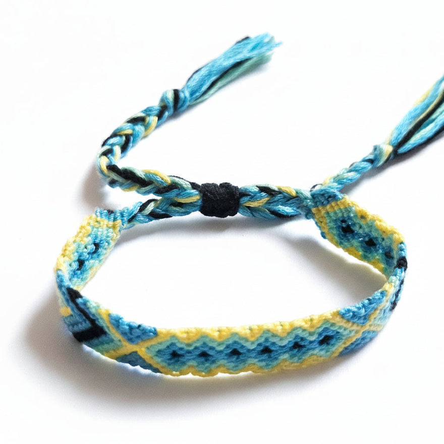 Hand-knotted blue and yellow cotton friendship bracelet with diamond pattern – product view