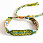 Hand-knotted green, yellow and orange cotton friendship bracelet with diamond pattern – product view
