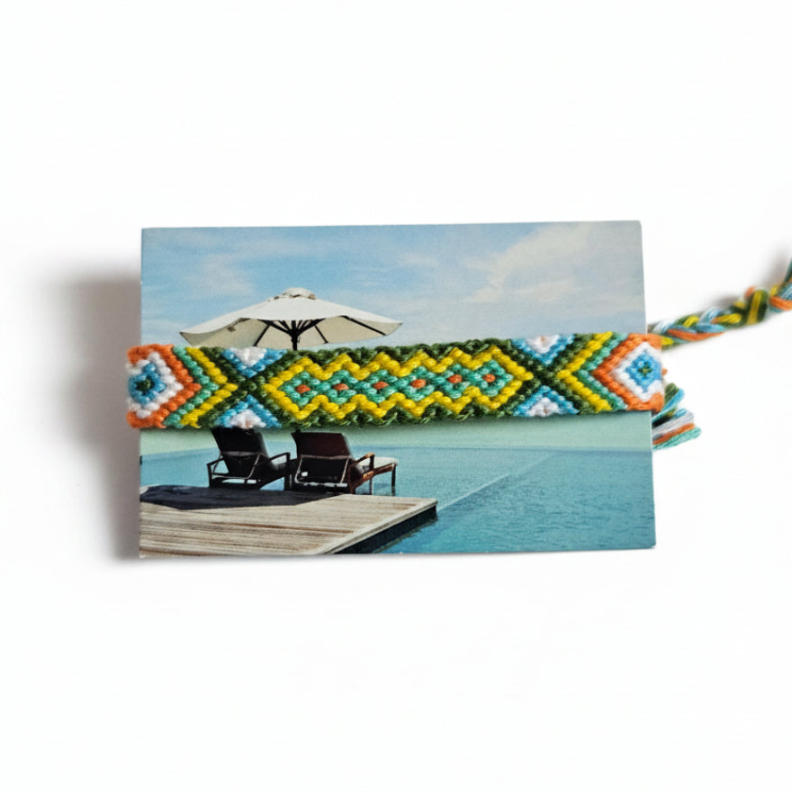 Hand-knotted green, yellow and orange cotton friendship bracelet with diamond pattern