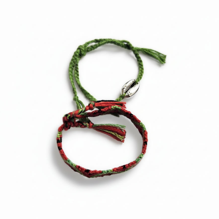 Red and green hand-knotted cotton friendship bracelet set with chevron pattern and green cord bracelet with silver cowrie shell charm – product view