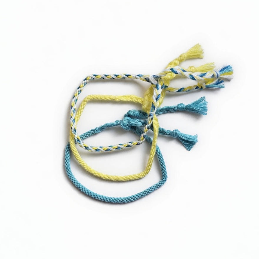 Blue, yellow and white hand-knotted cotton friendship bracelet set of 3 – product view