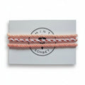 Peach, coral and white hand-knotted cotton friendship bracelet set of 3 on Mint Sorbet packaging card