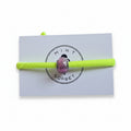 Neon yellow elastic bracelet with pink Murano glass bead on Mint Sorbet packaging