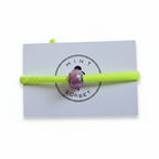 Neon yellow elastic bracelet with pink Murano glass bead on Mint Sorbet packaging