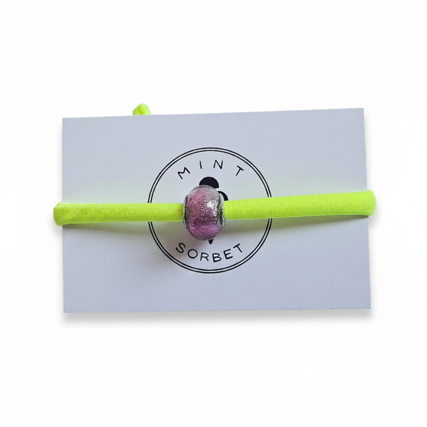 Neon yellow elastic bracelet with pink Murano glass bead on Mint Sorbet packaging