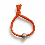 Orange elastic bracelet with gold and silver Murano glass bead – product view