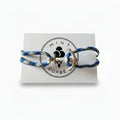 Blue and white patterned nautical rope bracelet with silver stainless steel anchor clasp on Mint Sorbet packaging card