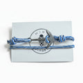 Blue and white striped nautical rope bracelet with silver stainless steel anchor clasp on Mint Sorbet packaging card