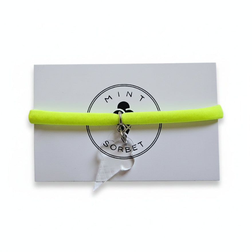 Neon yellow nylon elastic bracelet with transparent acrylic ice cream cone pendant on Mint Sorbet packaging card