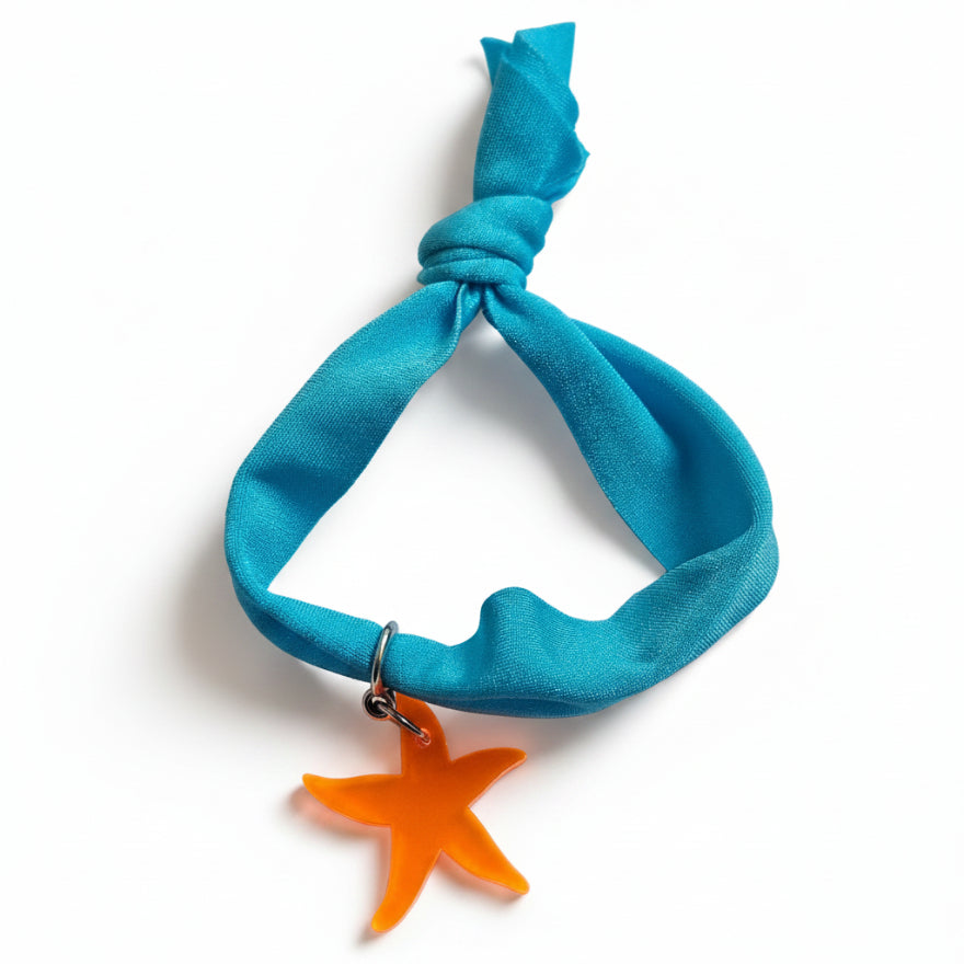 Turquoise nylon elastic bracelet with orange acrylic starfish pendant – product view