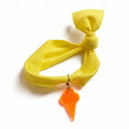 Yellow nylon elastic bracelet with orange acrylic ice cream cone pendant – product view