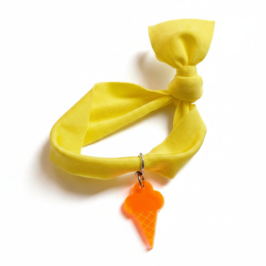 Yellow nylon elastic bracelet with orange acrylic ice cream cone pendant – product view