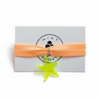 Peach nylon elastic bracelet with neon green acrylic starfish pendant on Mint Sorbet packaging card