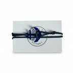Dark blue paracord bracelet with blue acrylic anchor pendant on Mint Sorbet packaging card