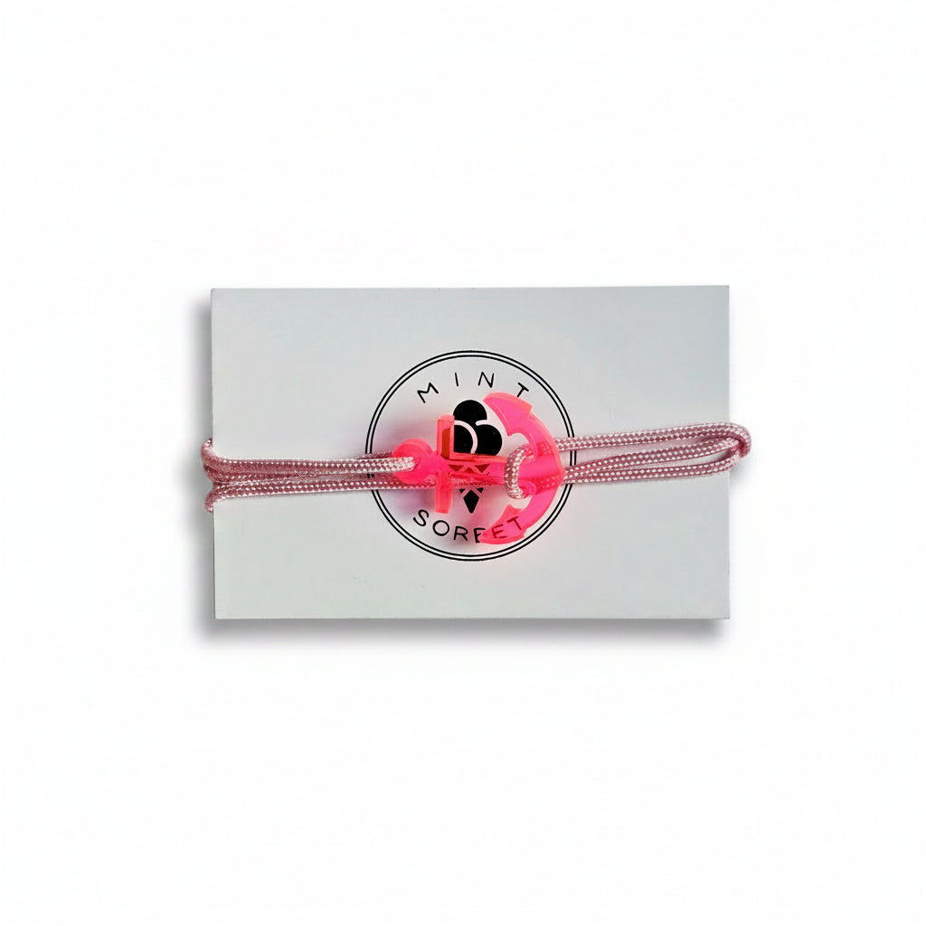 Pink paracord bracelet with neon pink acrylic anchor pendant on Mint Sorbet packaging card