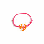 Pink paracord bracelet with neon orange acrylic anchor pendant – product view