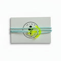 Light blue paracord bracelet with neon yellow acrylic anchor pendant on Mint Sorbet packaging card