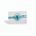 Light blue paracord bracelet with transparent blue acrylic anchor pendant on Mint Sorbet packaging card