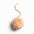 Orange cotton and polyacrylic yarn pom pom charm – product view