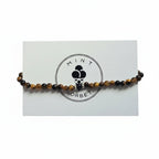 Brown Tiger's Eye and black lava stone beaded bracelet with silver accent bead on Mint Sorbet packaging card
