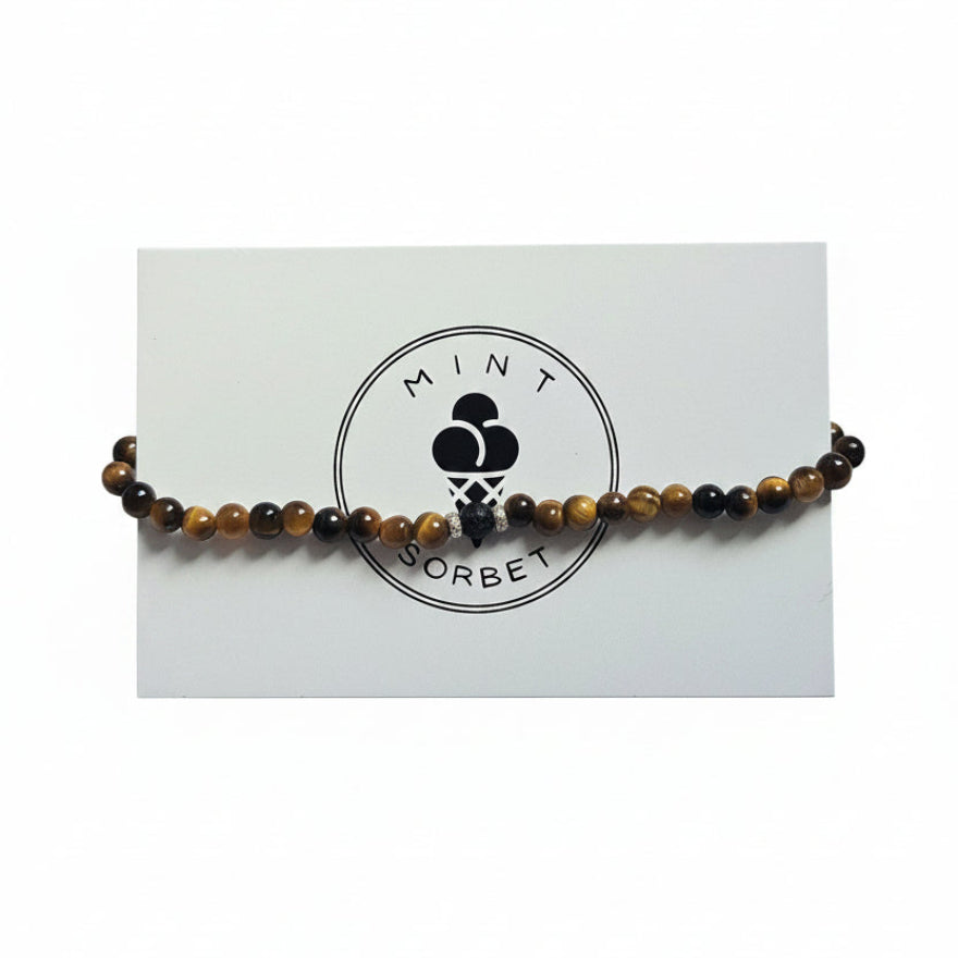 Brown Tiger's Eye and black lava stone beaded bracelet with silver accent bead on Mint Sorbet packaging card
