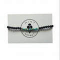 Black onyx and turquoise amazonite beaded bracelet with silver accent bead on Mint Sorbet packaging card