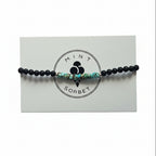 Black onyx and turquoise amazonite beaded bracelet with silver accent bead on Mint Sorbet packaging card
