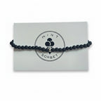 Black lava stone and black tourmaline beaded bracelet with silver accent beads on Mint Sorbet packaging card